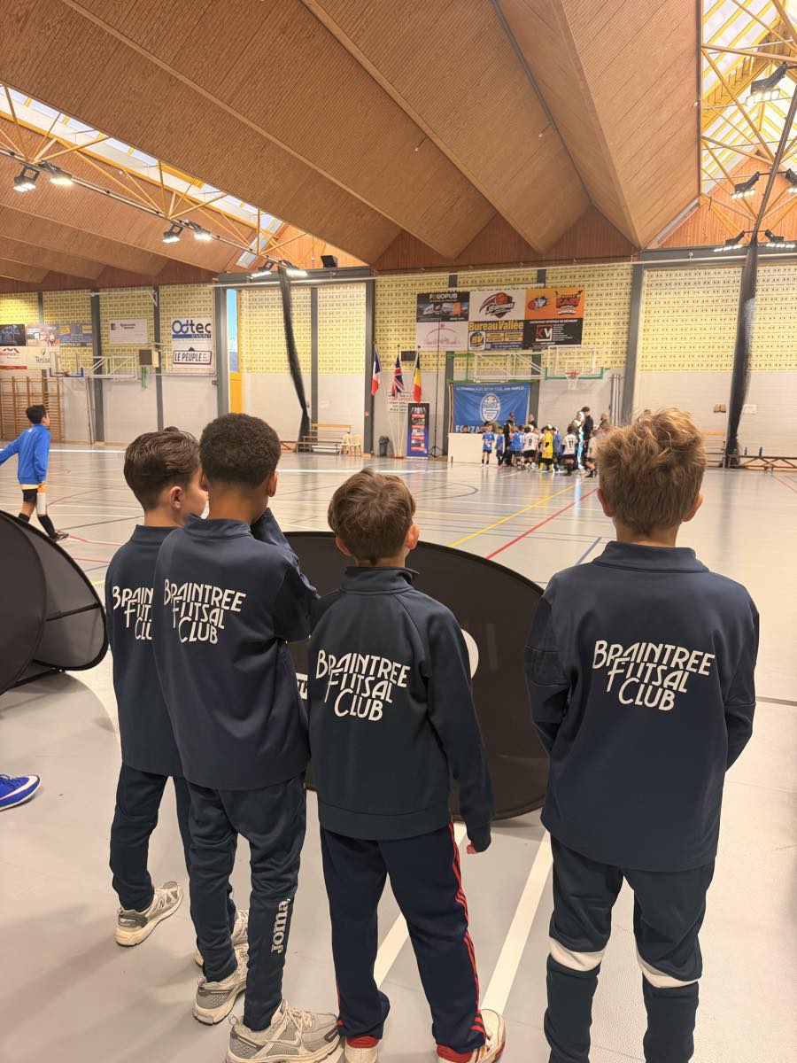 Braintree players watch futsal from the side of the court.