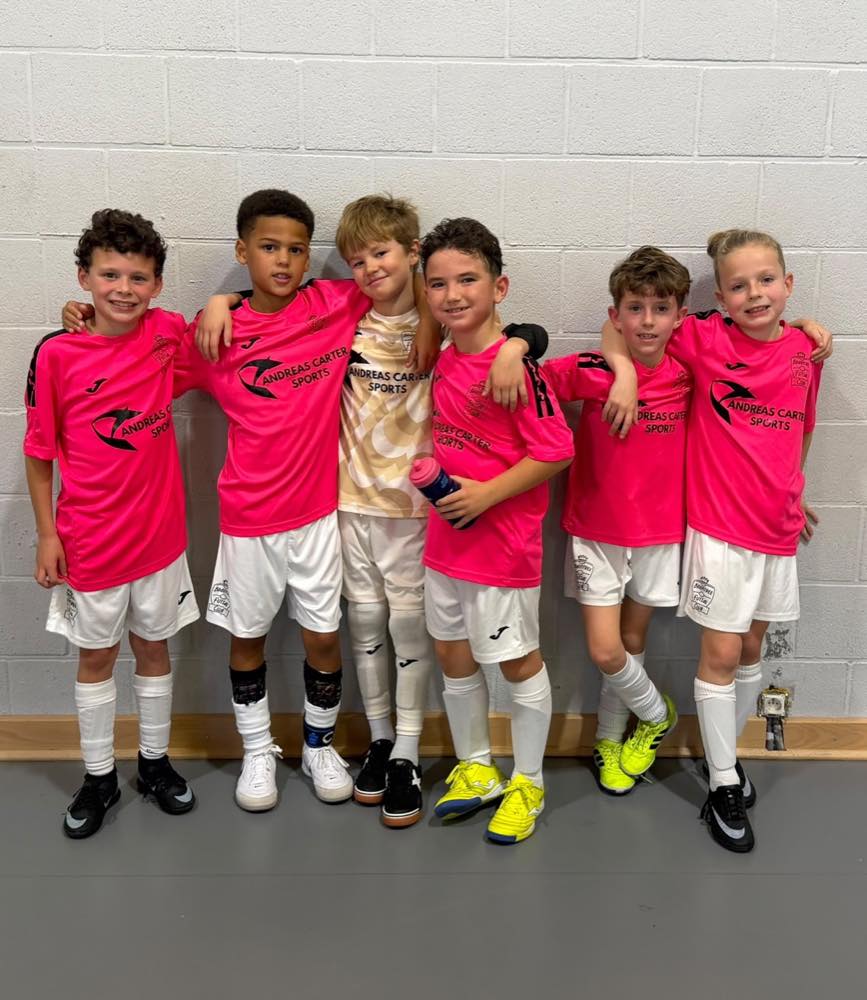 Six Braintree Under-9 players stand together in their match kits.