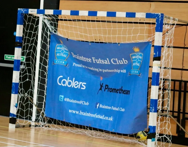A historical Braintree club and partner banner hanging across a futsal goal