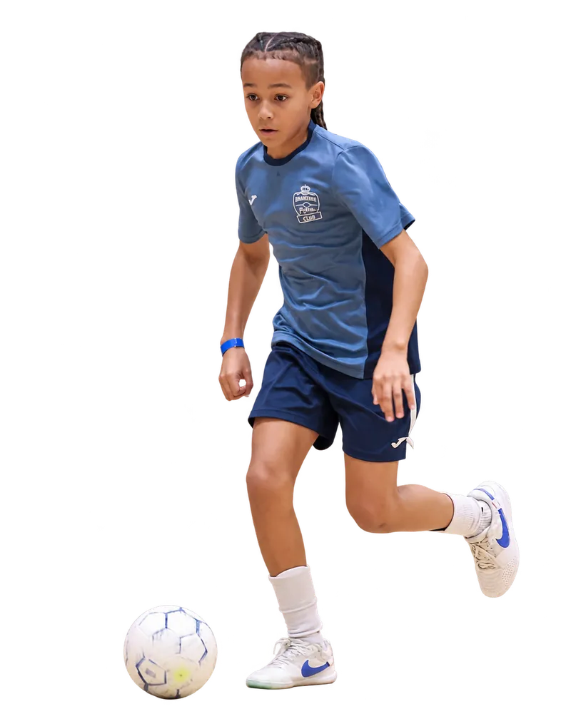 Young Braintree Futsal player in the original grey-blue top controlling a white ball