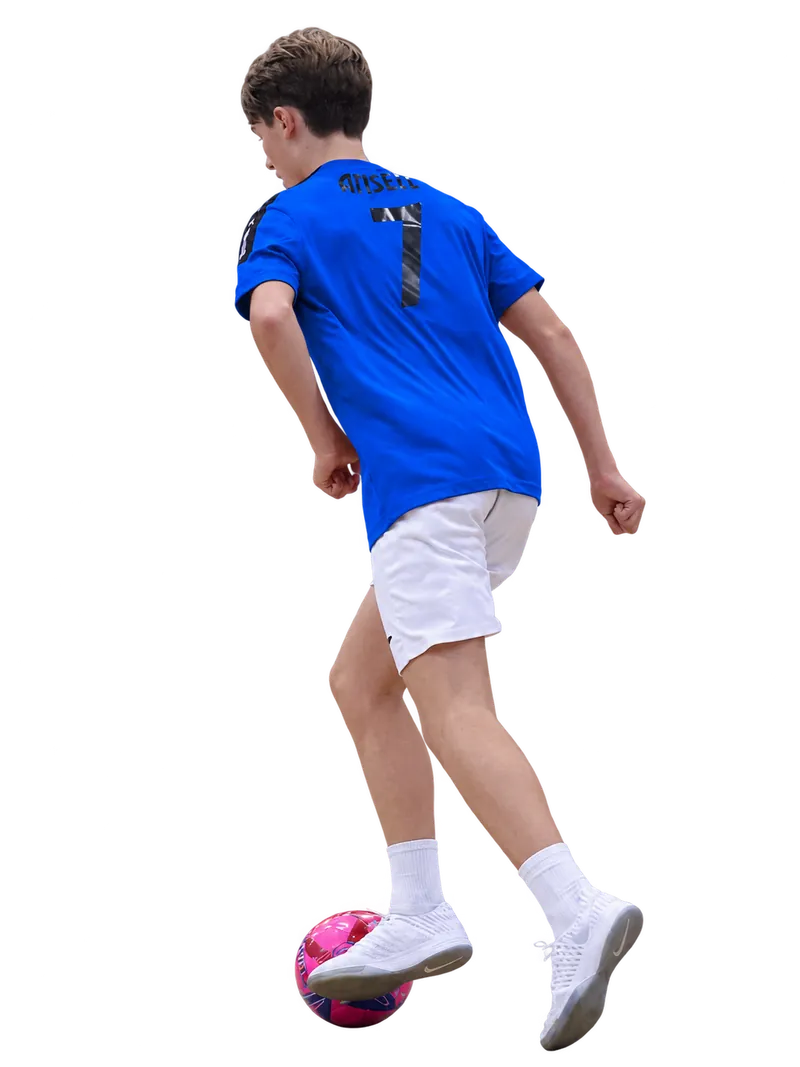 Young Braintree Futsal player in a blue number seven shirt controlling a pink ball