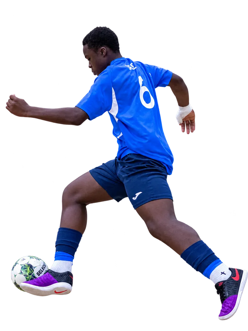 Braintree Futsal player in a blue number six shirt playing a green and white ball