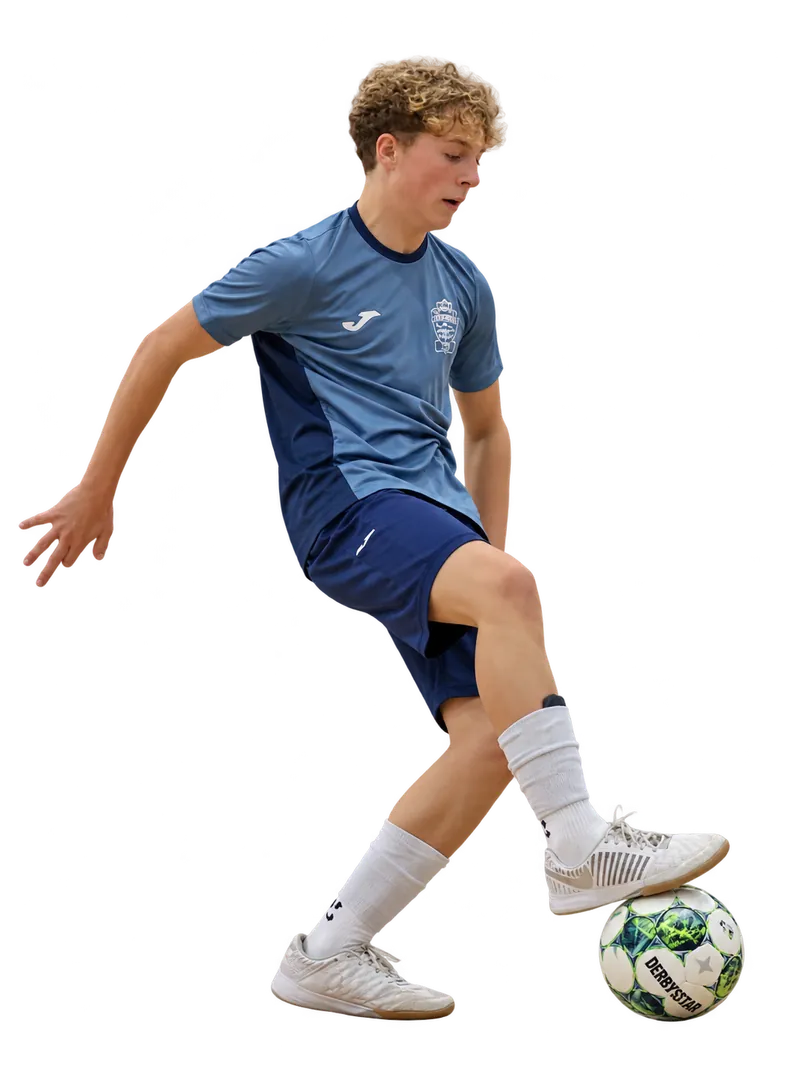 Young Braintree Futsal player in the original grey-blue top controlling a green and white ball