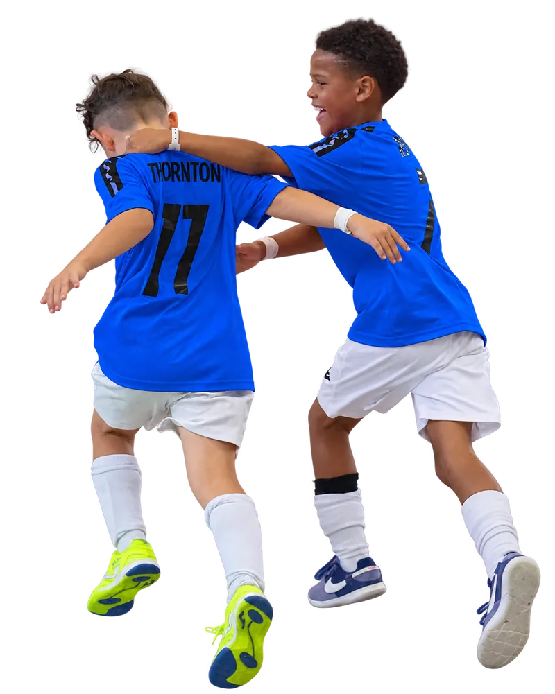 Two young Braintree Futsal players in blue shirts celebrating together